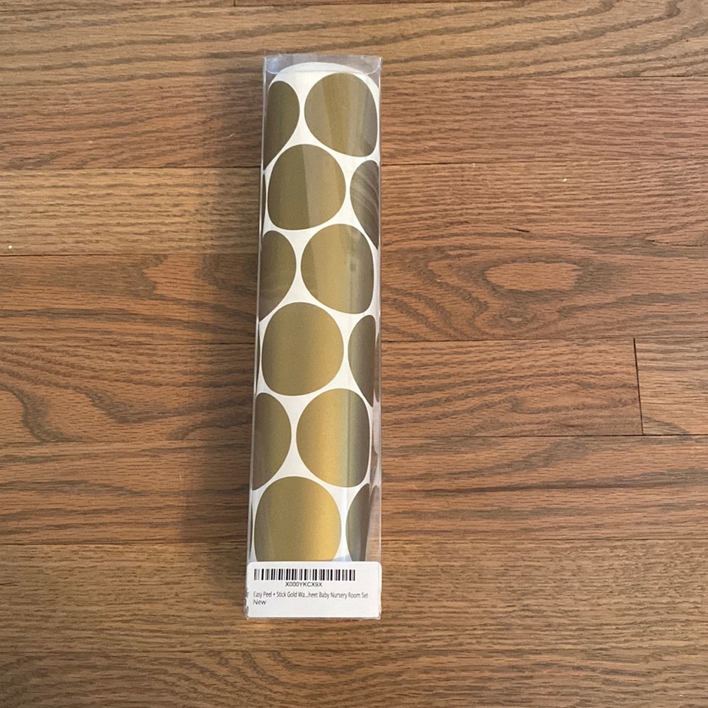 Brand new, unopened, easy stick and peel gold wallpaper dots.